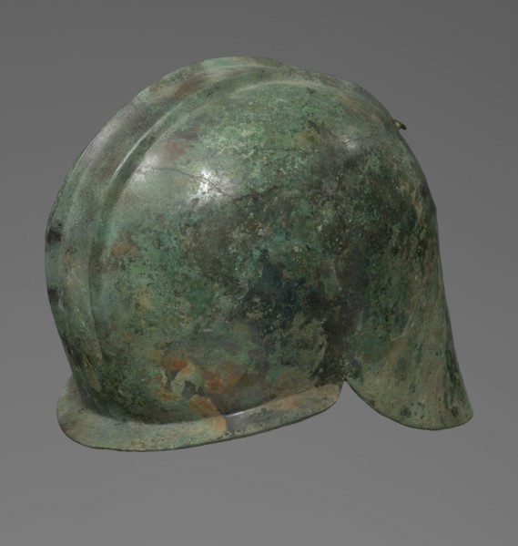 Bronze helmet with rectilinear cutouts for the eyes, nose, mouth, and chin; two prominent