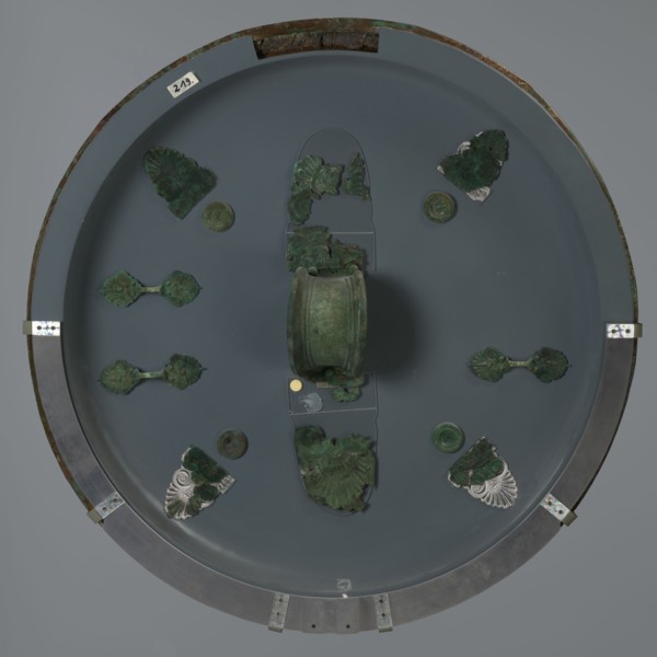 Hoplite shield, 6th century BC, Italy, weaponry, A round display with a muted gray background holds