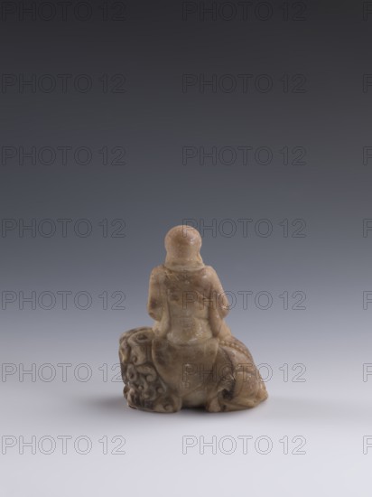 Luohan on a lion;, arhat iconography; lion iconography; figurine; Chinese art; Chinese culture;