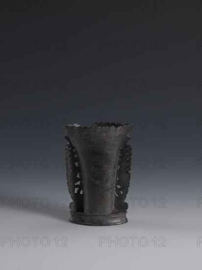 Vase, flattened vase made of dark soapstone with bas-relief and openwork in places, engraved. One