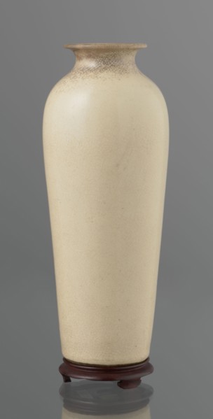 Vase on saucer. Cylindrical porcelain vase tapering toward the bottom with a flat rim. Light cream