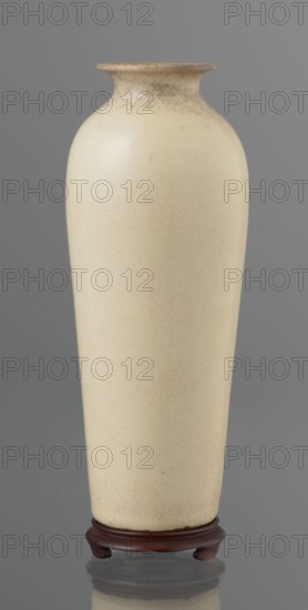 Cylindrical porcelain vase tapering toward the bottom with a flat rim; light cream glaze with fine