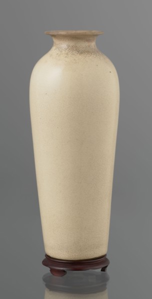 Cylindrical porcelain vase tapering toward the bottom with a flat rim; light cream glaze with fine