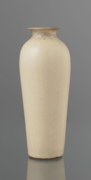 Vase on saucer. Cylindrical porcelain vase tapering toward the bottom with a flat rim; light cream