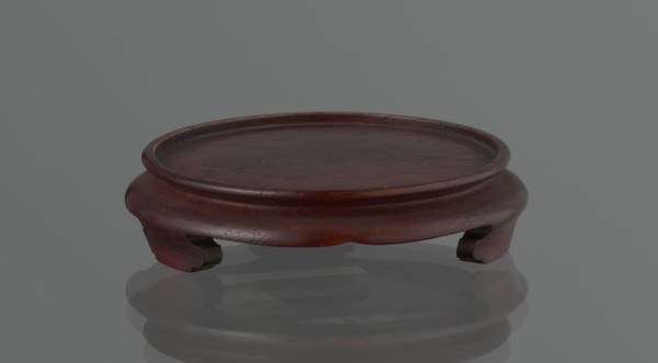 Vase on saucer. Cylindrical porcelain vase tapering toward the bottom with a flat rim. Light cream
