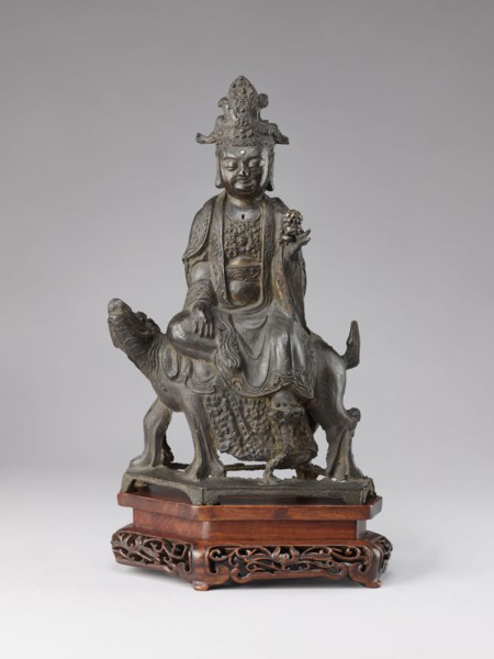 Buddhist deity on a buffalo, on a base; figurine; Chinese; Chinese Buddhism; lotus iconography;