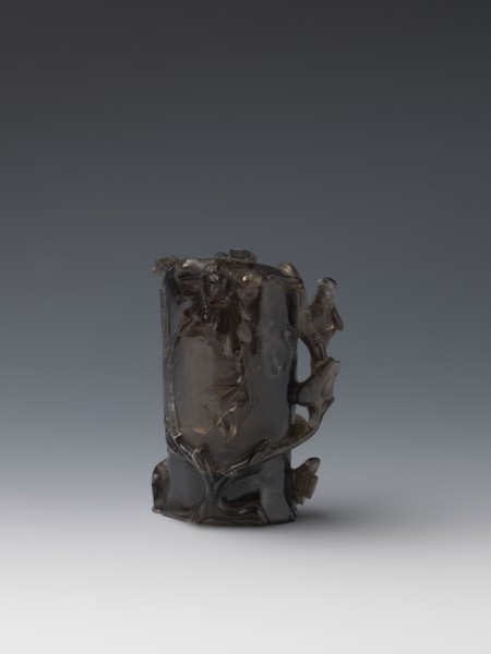 Vase on base, carved ornaments of flowers, birds, and stylized rocks; wooden oval base on three