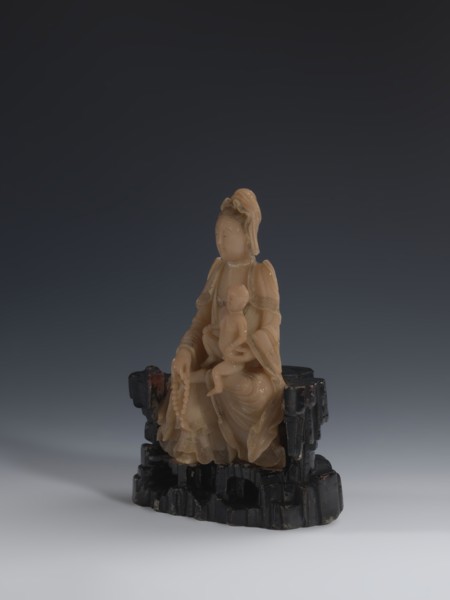 Guanyin Giving Birth to a Son on a Rock; sculptor unknown. Figurine of the goddess made of light