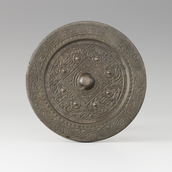 Mirror with TLV decoration on a pedestal in the form of a qilin on a base. Chinese, Qing dynasty