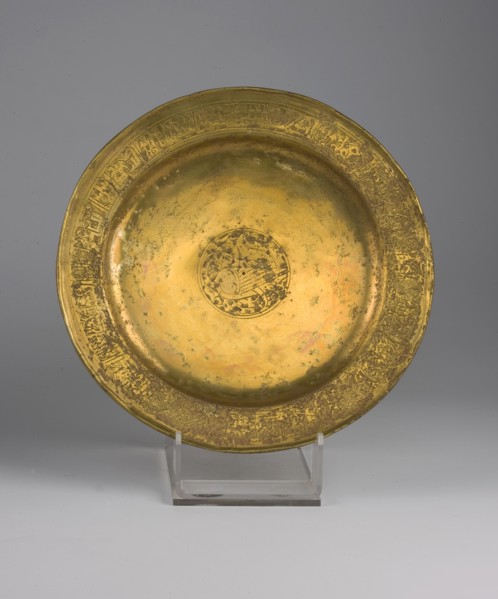 Flat metal plate with a slightly raised rim, 13th century, Iran. Diameter 20.8 cm, height 2.2 cm,