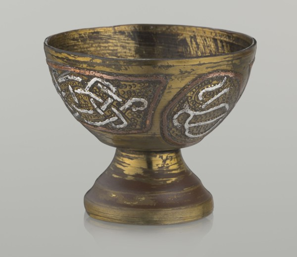 Bowl, decorated with braid and stylized Arabic inscriptions in cartouches on a punched background;