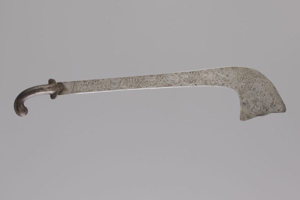 Sabre of the bark type, Indian culture. With a curved hilt and a similarly expanded engraving.
