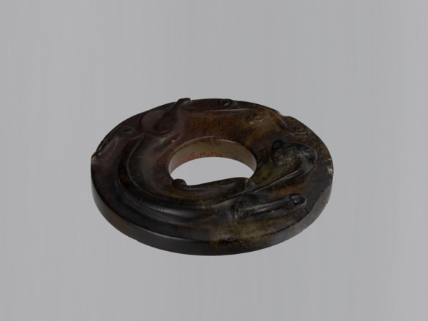 Disc with stylized antique-style decoration showing an entwining image of a lizard, stone almost
