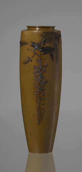 A slender miniature vase, with a belly widening slightly towards the top and narrow, straight arms.