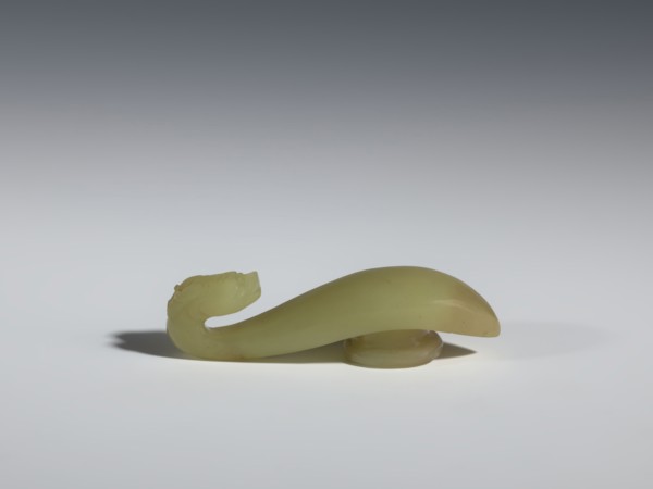 Belt clasp;, Jadeite with visible clusters of colloids in a green hue; pointed handle and slightly