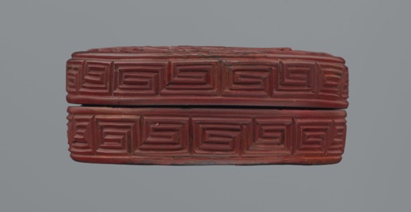 Box with lid; Chinese; red lacquer carved with meander leiwen, cloud and Buddhist ornament; reeds