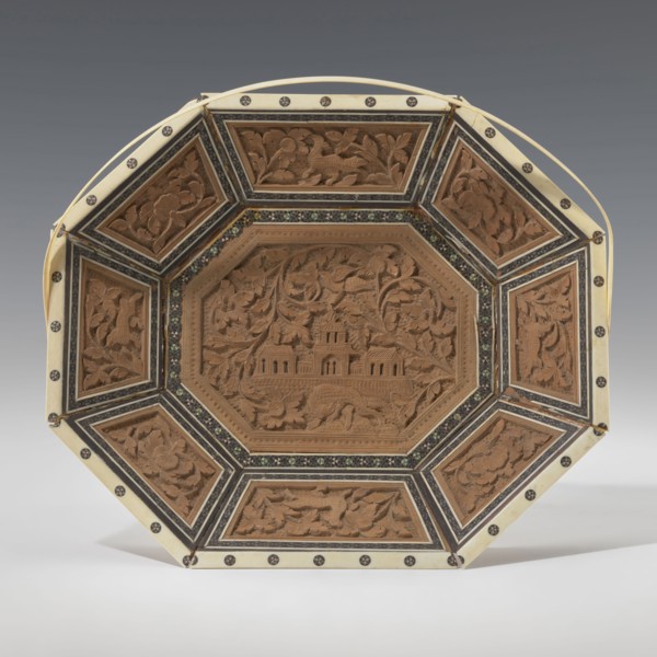 Basket. Octagonal, shallow wooden basket with an ivory rim and handle. Inside the basket is a