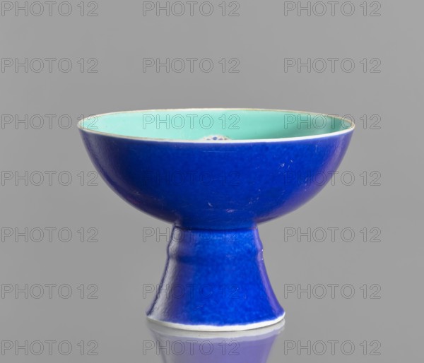 A porcelain footed bowl, Chinese, 19th century Qing Dynasty. Cobalt blue exterior glaze, green