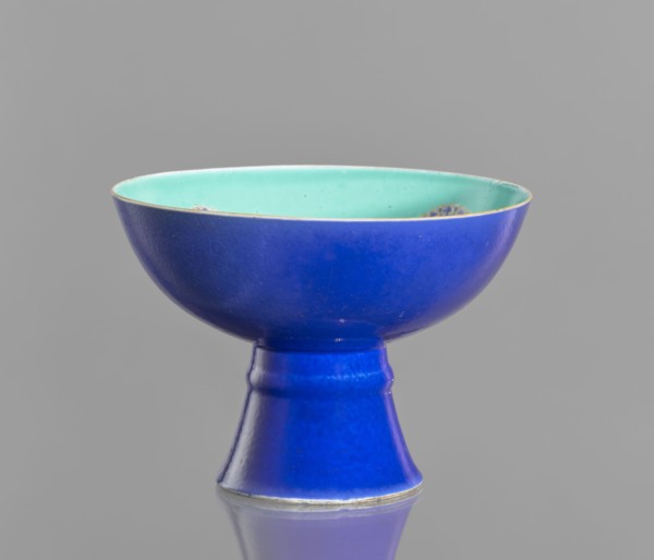 A tall footed porcelain bowl, Chinese, 19th century Qing Dynasty. Outer glaze stained cobalt, inner