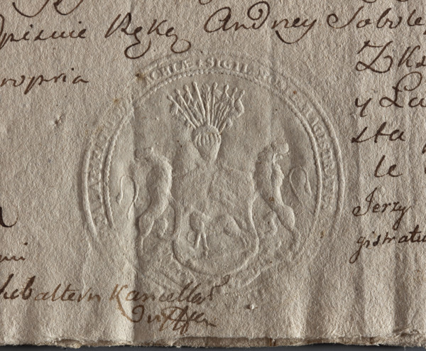 Round seal impression of the town of Kleszczele, Podlaskie Voivodeship. A shield supported by two