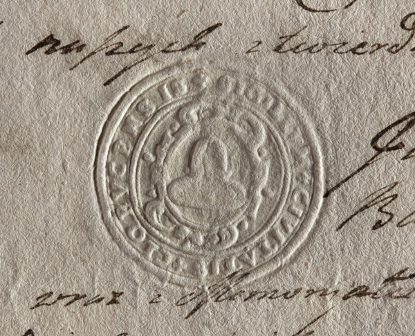 Round seal impression of the town of Klobuck, Kraków Voivodeship. On a decorative Baroque shield, a