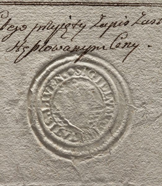 Round seal impression of the town of Liwa. City wall with three towers. Inscription around the rim: