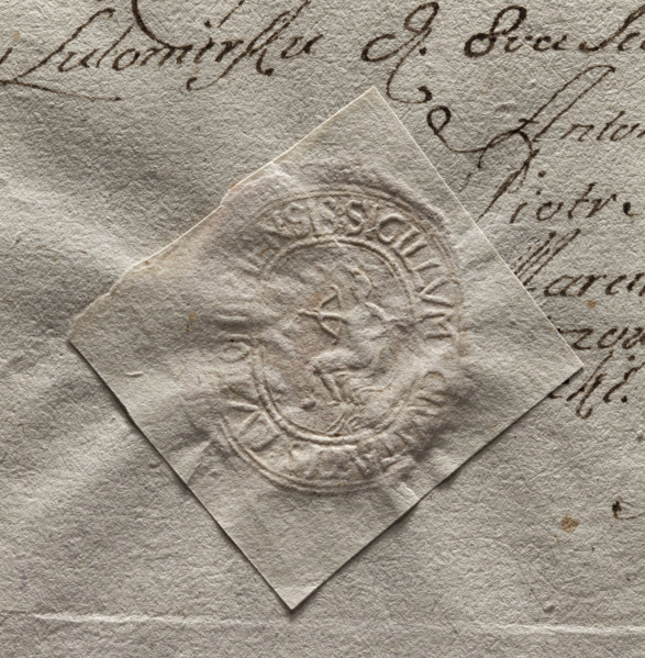 Oval seal impression of the town of Lutomiersk. In the central part—a seated figure holding a