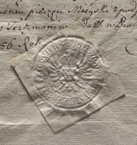 Round seal impression of the town of Piotrków. A crowned eagle with a shield bearing the Ciolek