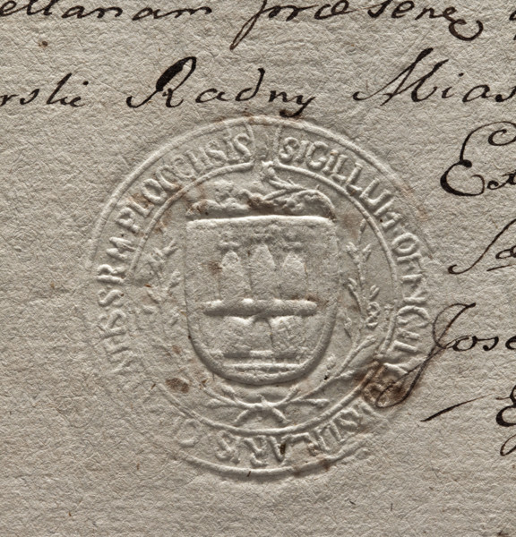 Round imprint of the city seal of Plock. On a vertically hatched shield surrounded by laurel
