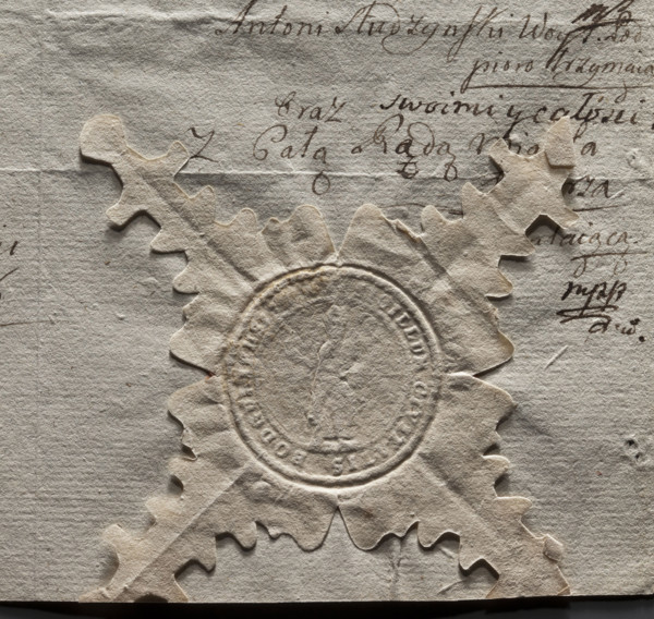 Round seal impression of the town of Podgórz. In the field of the seal, a standing figure of a