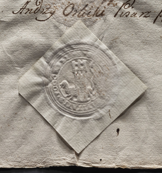 Round imprint of the city seal of Pogorzela. Tower with a gate and three battlements; behind it a
