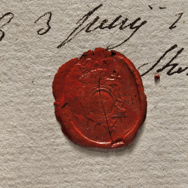 Round imprint of the seal of the town of Stopnica. In a decorative cartouche a key—bit upward.