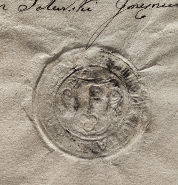 Round seal impression of the town of Stopnica. In a decorative cartouche, a key with its teeth up.