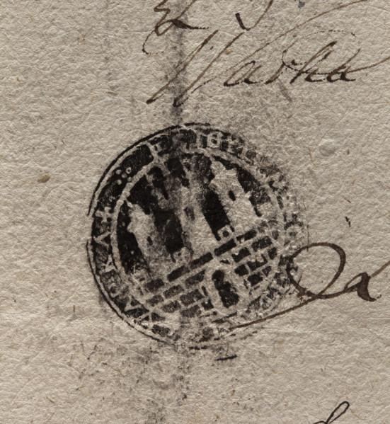 Round ink print of the seal of the town of Warka. City wall with an open gate and battlements.
