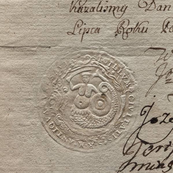 Round impression of the seal of the city of Warsaw. In a Baroque cartouche a mermaid with a fish
