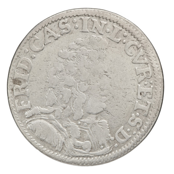 Obv. In the border a male bust in armor and a wig turned to the right, separating the inscription