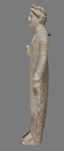 Votive figure of a youth holding a bird, Cypriot votive sculpture. Figurine of a youth shown