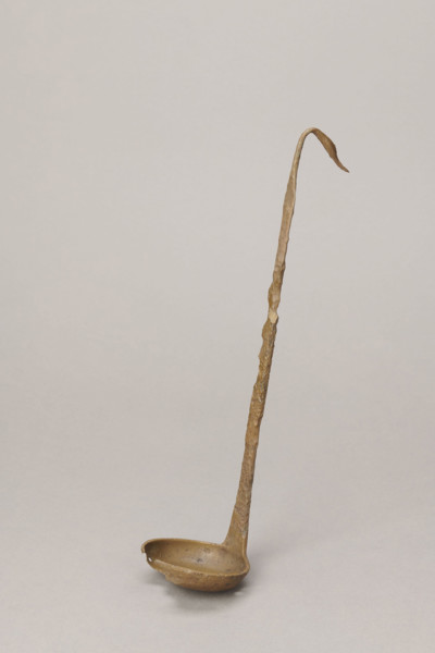 Shallow dipper with a quadrilateral handle, narrowed at the top. The end of the handle is in the