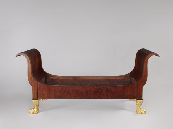 Bed with animal-paw legs in Empire style for bedrooms. Mahogany bed with S-shaped outward-curving