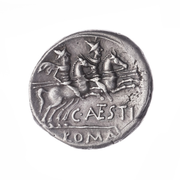 Denarius, obverse head of Roma in helmet at right; behind her a dog; in front of her a sign of