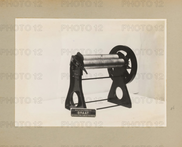 Roller press, album page, photograph, Album page with a photo of a type of roller press. Part of a