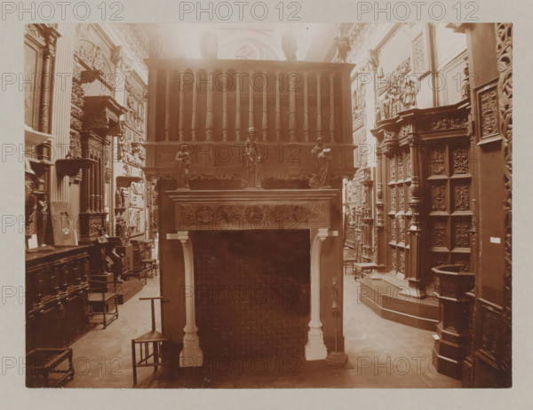 View of a hall with a fireplace and reliefs, album page, photograph, This album page is part of a