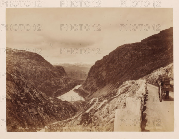 View from Reldalsfjeldet with mountains around it, Norway, photograph, View over a deep valley