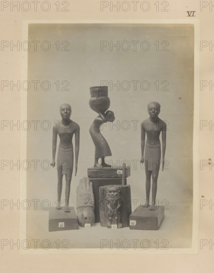 Five Egyptian objects, including two sculptures of boys and a wooden kohl pot with the image of