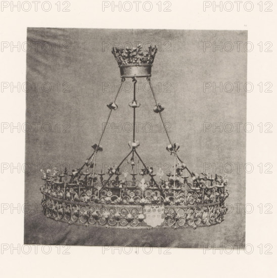 Wrought-iron chandelier from St. Peter's Church in Bastogne, displayed at an exhibition on
