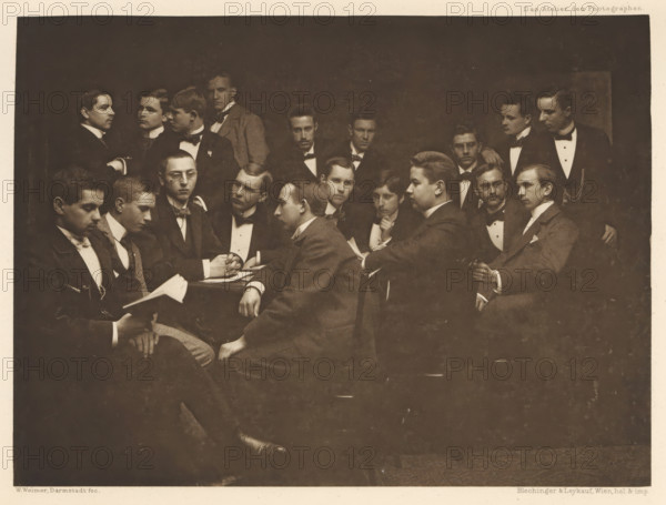 Group of men in suits, including one with a book in hand, page, photomechanical print,
