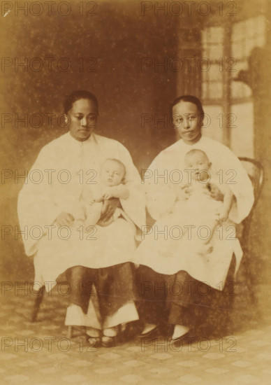 Portrait of two unknown Chinese nannies with babies on their laps, Chinese Amahs, photograph, page,