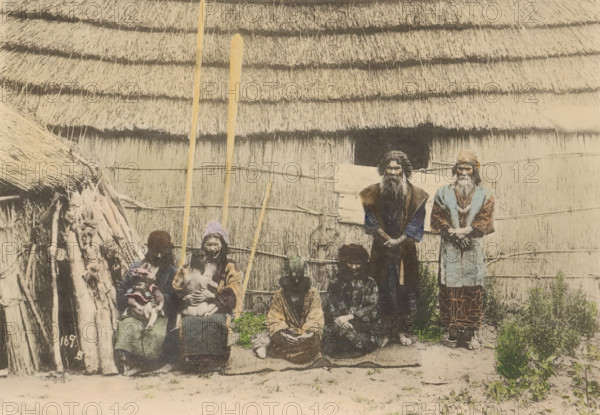 Ainues, the Native of Hokkaido, Japan, Portrait of unknown people of the Aino in front of a house