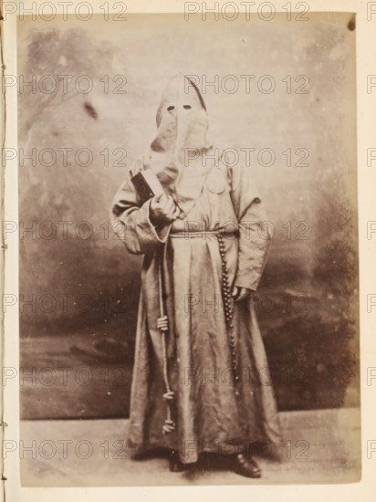 Portrait of someone in a monk's habit and with a hood over their head, photograph, page, Italy, c.