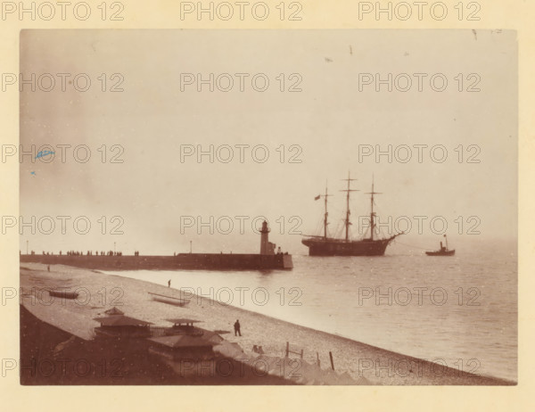 Tugboat takes sailing ship in tow at a harbor pier, photograph, Part of a French artist's album., c
